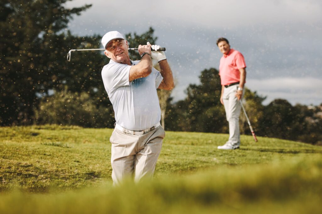 Man playing golf after treatment from a shoulder specialist