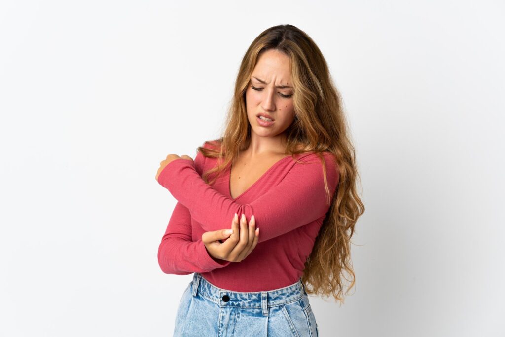 Young blonde woman with serious elbow pain