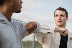 Two men hitting elbows