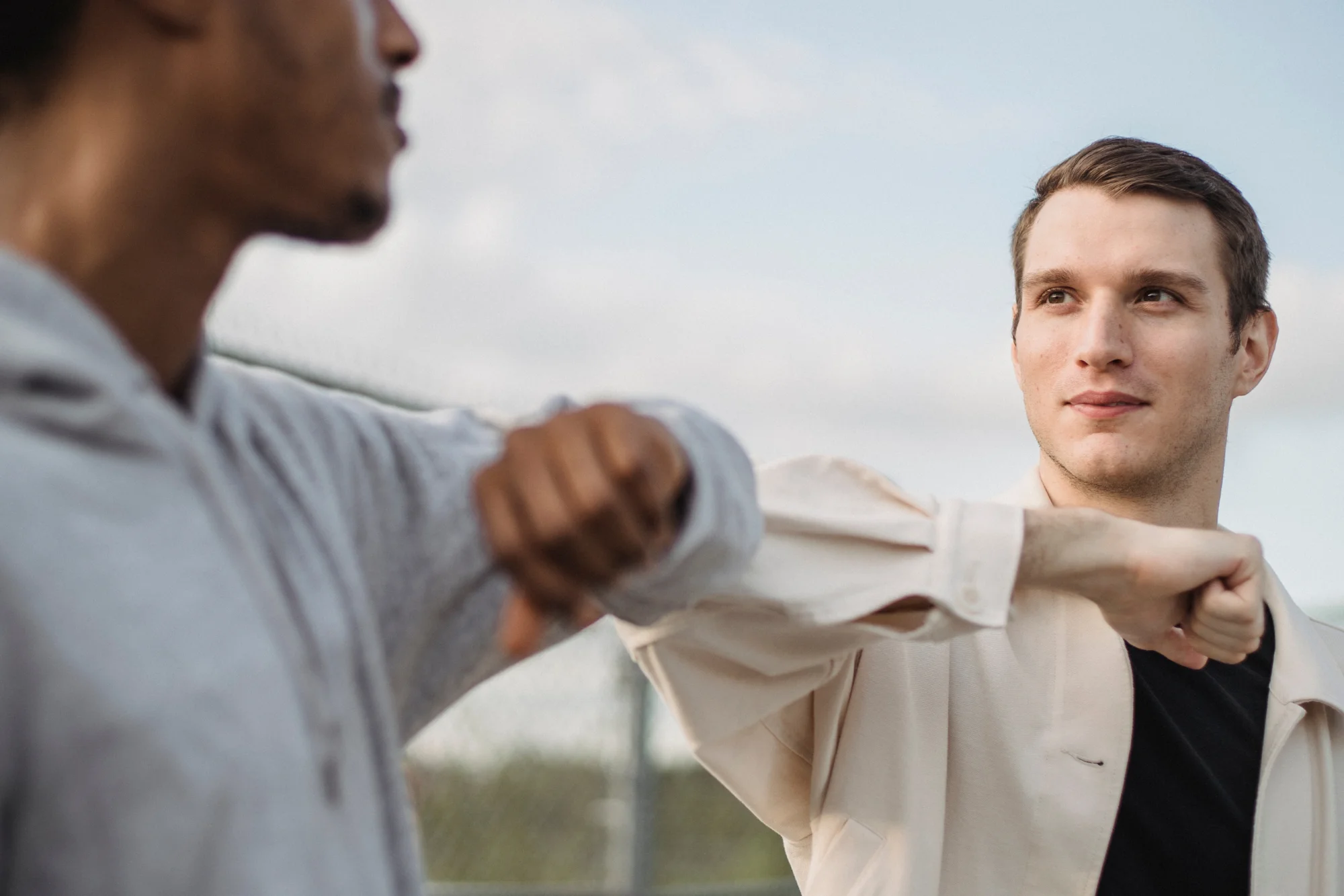 Two men hitting elbows